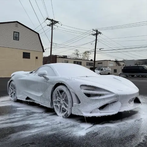 Car wheels coated in brake dust and grime before cleaning in Mississauga.