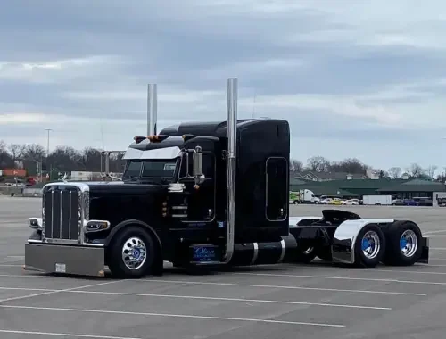 Detailer vacuuming a tractor cab and sleeper area.