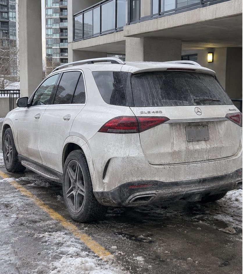 White Mercedes GLE rear end coated in winter road salt and grime