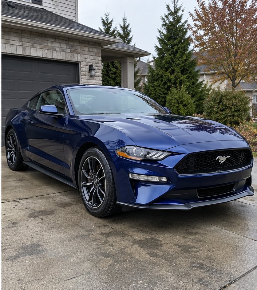 The same blue Ford Mustang front end washed and waxed to a clean, glossy finish