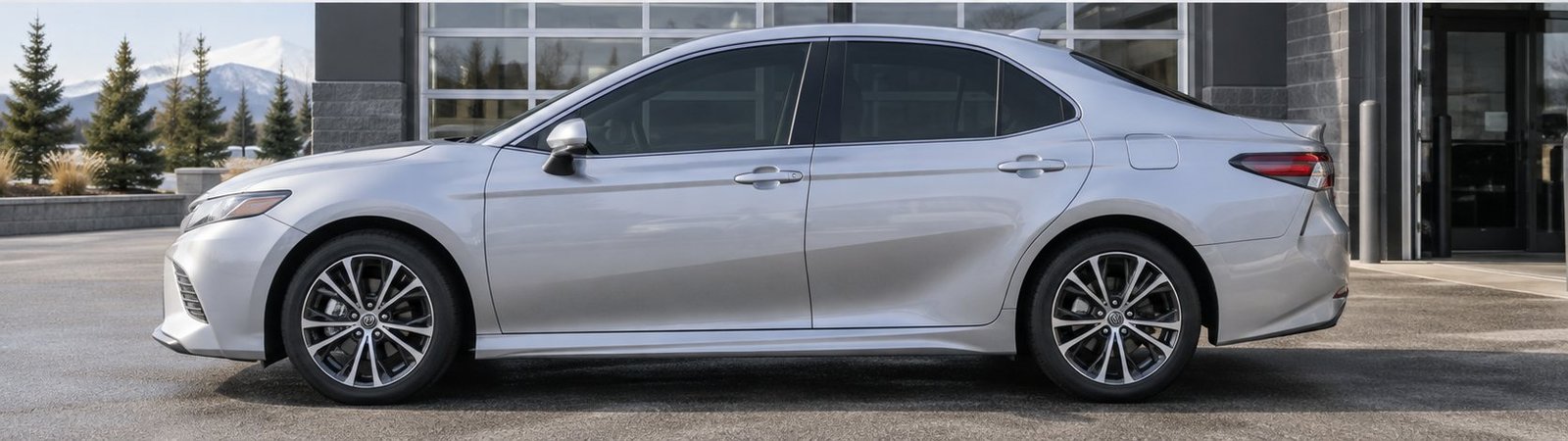 The same silver sedan side profile with darker professionally tinted side windows